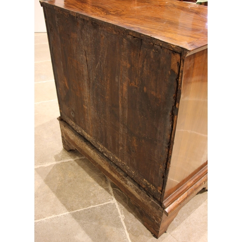 686 - A George I walnut chest on stand, the quarter veneered and feather banded top over an arrangement of... 