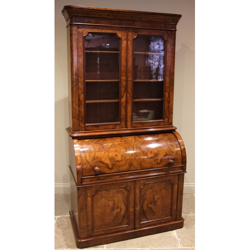 742 - A Victorian burr walnut cylinder bureau bookcase, the moulded and rounded cornice over a pair of gla... 