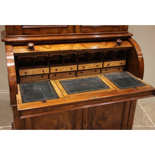 742 - A Victorian burr walnut cylinder bureau bookcase, the moulded and rounded cornice over a pair of gla... 