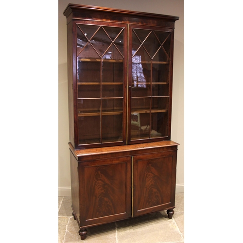 752 - A 19th century flame mahogany library bookcase, the moulded cornice over a pair of astragal glazed d... 