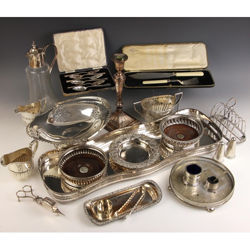 52 - A large selection of silver-plated items, including a swing handled basket, 30cm wide, two bottle co... 