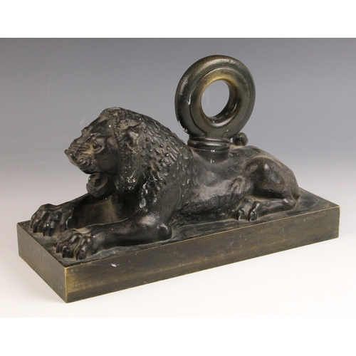 549 - A Regency patinated bronze door porter, early 19th century, modelled as a snarling recumbent lion wi... 