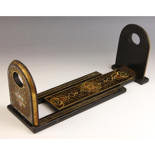 554 - A Victorian black lacquered book slide, late 19th century, of typical form, inset with mother of pea... 