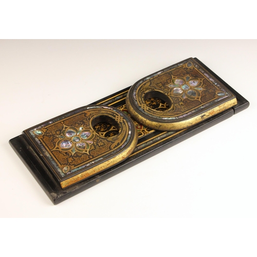 554 - A Victorian black lacquered book slide, late 19th century, of typical form, inset with mother of pea... 