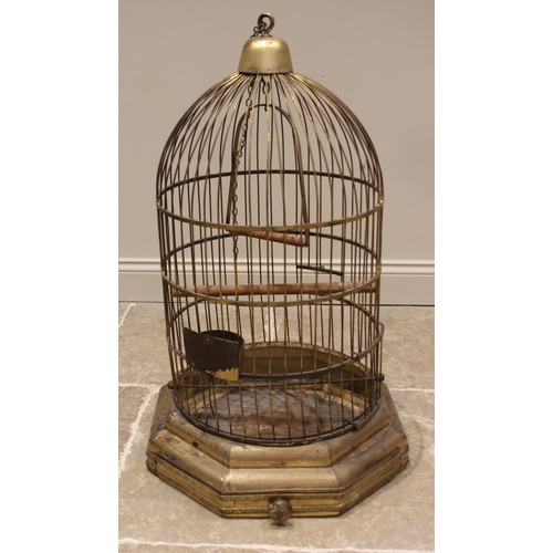 572 - A Victorian patinated brass parrot/bird cage, of typical domed form, fitted with a swing, perch, fee... 