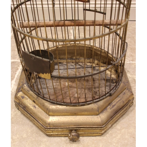 572 - A Victorian patinated brass parrot/bird cage, of typical domed form, fitted with a swing, perch, fee... 