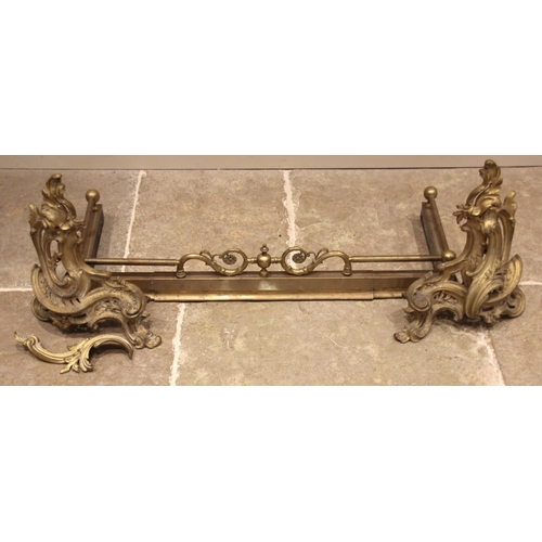 600 - A brass fire kerb, early 20th century, surmounted with a rail and scroll detail, 100cm wide, along w... 