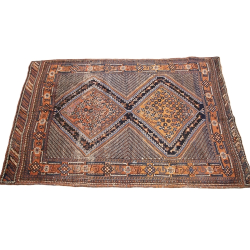 642 - A Persian Hamadan wool rug, in blue and rust colourways, the two central lozenge shaped medallions w... 