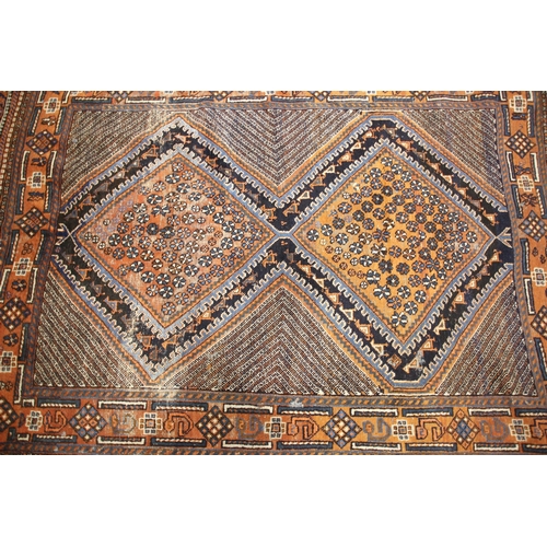 642 - A Persian Hamadan wool rug, in blue and rust colourways, the two central lozenge shaped medallions w... 