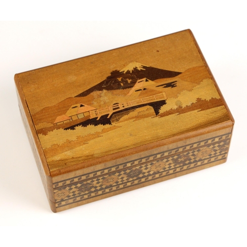 662 - A Chinese carved wood puzzle box, 20th century, designed as a fan, containing rock specimens from Uz... 