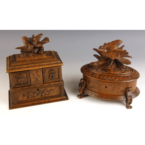 665 - A Black Forest linden wood jewellery casket, early 20th century, carved with a pair of birds upon a ... 