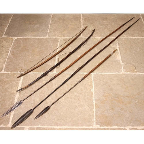 531 - Two East African Tribal bows, 134cm long and 122cm long, with three Samburu iron headed spears (5)