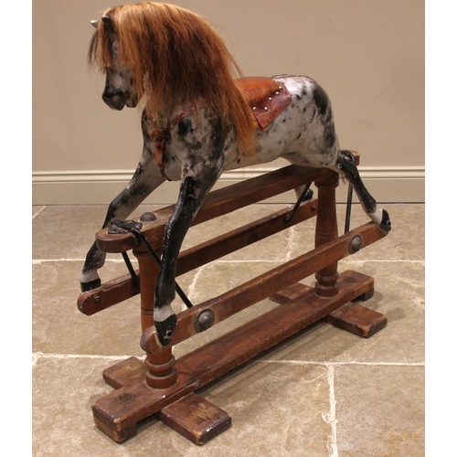 581 - A painted wooden dapple grey rocking horse, by Lines Bros for Tri-ang, early 20th century, with a la... 