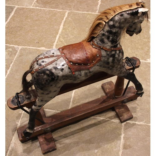 581 - A painted wooden dapple grey rocking horse, by Lines Bros for Tri-ang, early 20th century, with a la... 