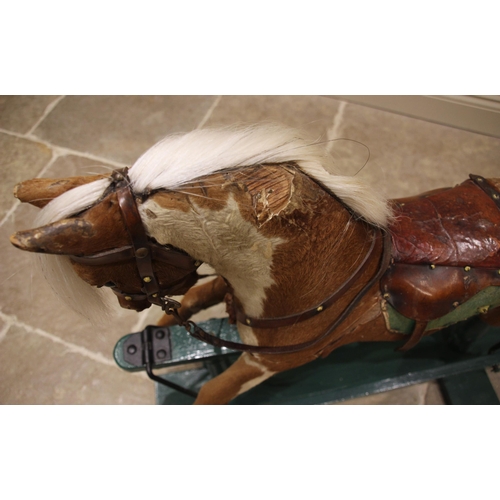 582 - A chestnut coloured pony hide rocking horse, late 19th/early 20th century, with applied white horse ... 