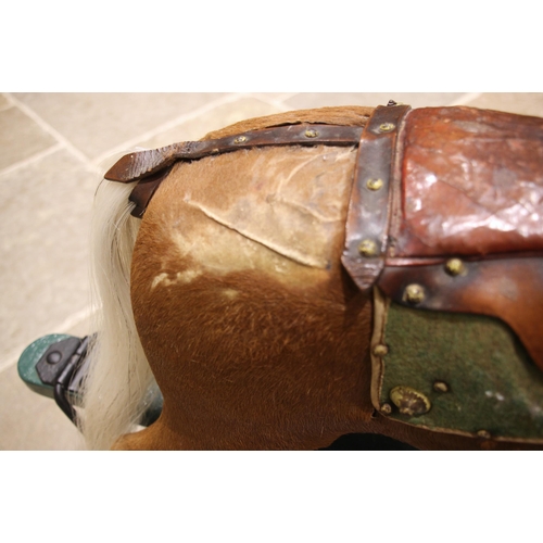 582 - A chestnut coloured pony hide rocking horse, late 19th/early 20th century, with applied white horse ... 