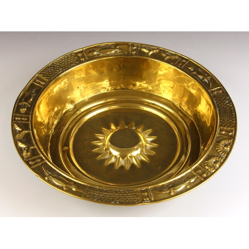 601 - A brass alms dish, probably Nuremburg 17th century, the rim cast in relief with zoomorphic motifs ar... 