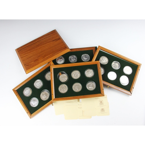 69 - A cased set of International Foreign Crown sized coins, including Mauritius 25 rupees, 50 rupees, 25... 