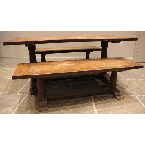 794 - A slab top teak table and conforming benches, the cleated table top upon twin baluster pedestals and... 