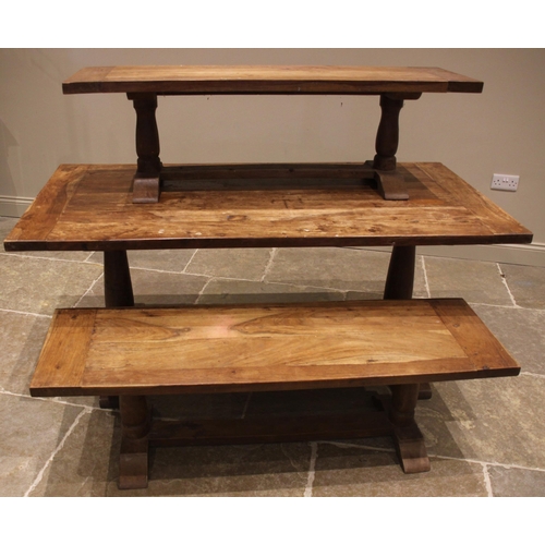 794 - A slab top teak table and conforming benches, the cleated table top upon twin baluster pedestals and... 