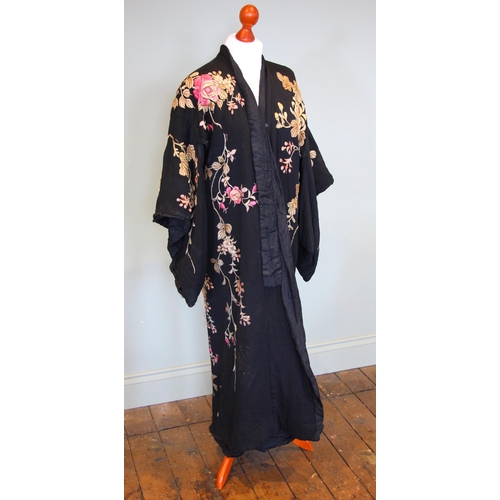 589 - An early-mid 20th century Japanese kimono, heavily embroidered in pink and gold with an abundance of... 