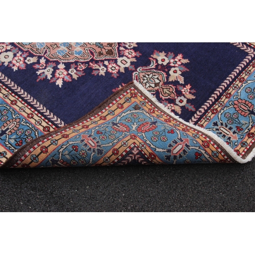 646 - A rich blue ground Persian Ardabil village rug, with a bespoke medallion design, within a sky blue b... 