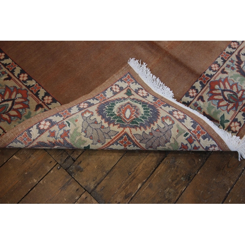 653 - A plain ground all over terracotta field Tabriz rug, with surrounding floral border, 200 x 150cm