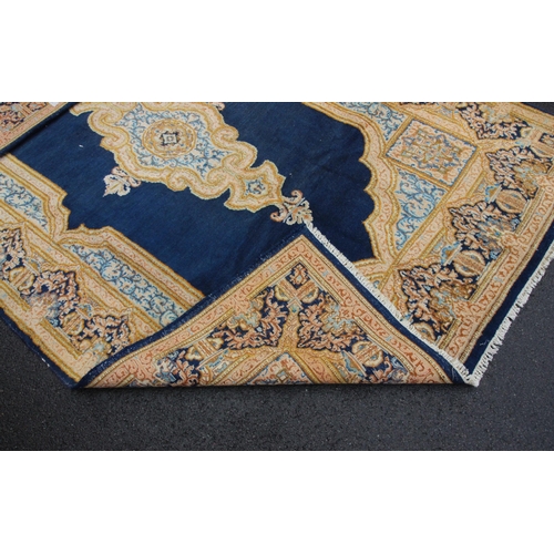 654 - A rich blue ground Kerman rug, with a bespoke medallion pattern, within a ogee shaped floral border,... 