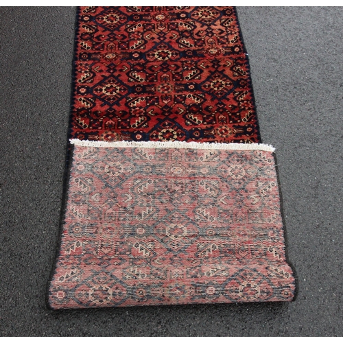 655 - A washed red ground Persian Hamadan runner, with an all over geometric design, 314 x 60cm