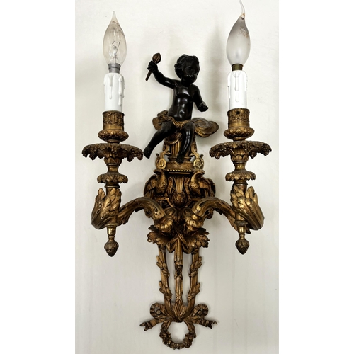 605 - A pair of French ormolu and bronze wall light sconces, each surmounted with the figure of a bronze c... 