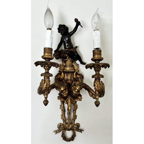 605 - A pair of French ormolu and bronze wall light sconces, each surmounted with the figure of a bronze c... 