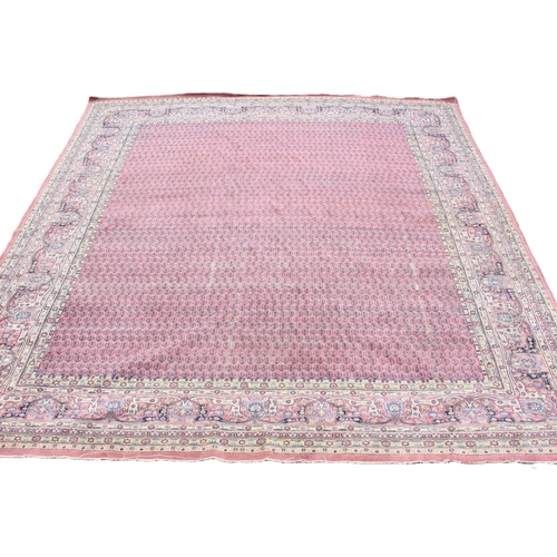 639 - A Persian pattern rug, the central pink field with an all-over gul design, enclosed by a trailing fo... 