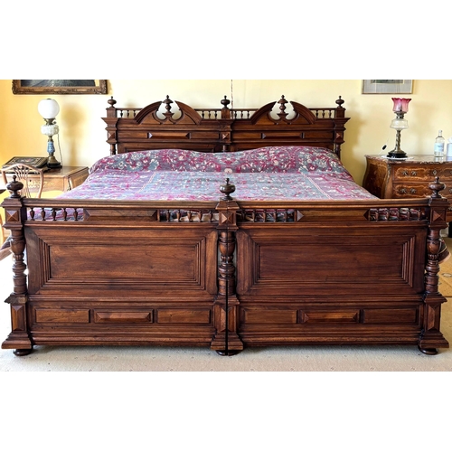 743 - A French walnut super king-size bed, early 20th century, constructed as two single beds, the headboa... 