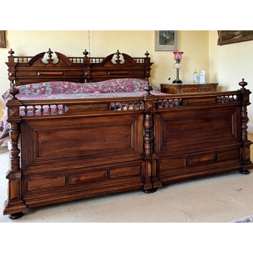 743 - A French walnut super king-size bed, early 20th century, constructed as two single beds, the headboa... 