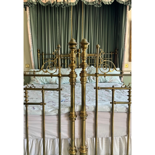 766 - A Victorian lacquered brass king-size bed frame, formed from twin single beds, each of the head and ... 