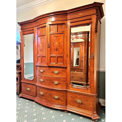 769 - An Edwardian satinwood breakfront wardrobe by Maple & Co, London, the moulded cornice over a frieze ... 