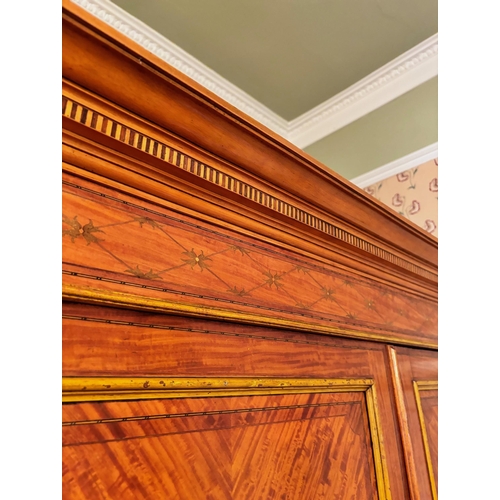 771 - An Edwardian satinwood linen press in the manner of Maple & Co, London, the moulded and simulated de... 