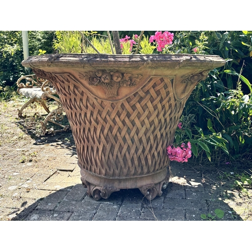 798 - A large and impressive pair of terracotta lattice work planters, of trumpet form, moulded in relief ... 