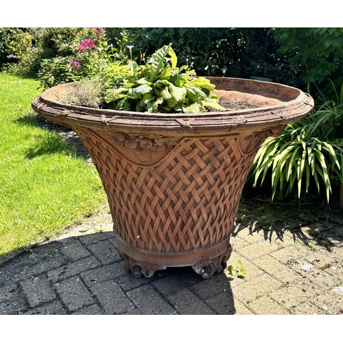 798 - A large and impressive pair of terracotta lattice work planters, of trumpet form, moulded in relief ... 