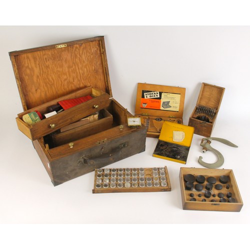 570 - A large collection of watch repairers tools and spares, to include cased stock and die, a fall front... 