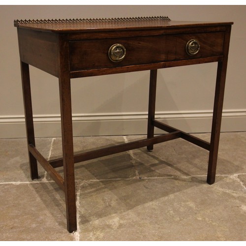 714 - A George III mahogany side table, with a rear open work brass gallery over the single oak lined frie... 