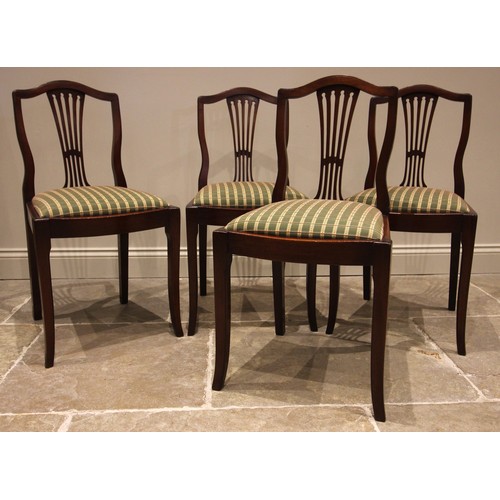 784 - A set of four mahogany dining chairs, early 20th century, each with a gently arched top rail over a ... 