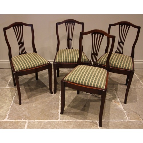 784 - A set of four mahogany dining chairs, early 20th century, each with a gently arched top rail over a ... 