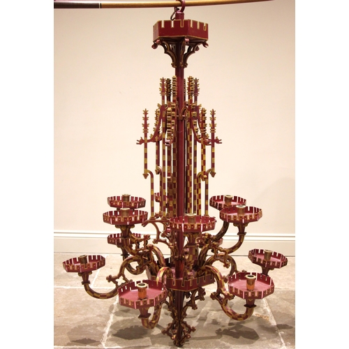 614 - A painted iron Puginesque chandelier, late 20th century, in red and yellow colourways, formed with a... 