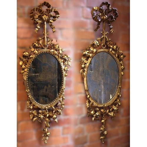 625 - A pair of giltwood and gesso wall mirrors, 19th century, each surmounted with a tied ribbon bow exte... 