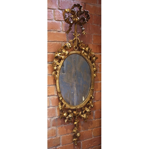 625 - A pair of giltwood and gesso wall mirrors, 19th century, each surmounted with a tied ribbon bow exte... 