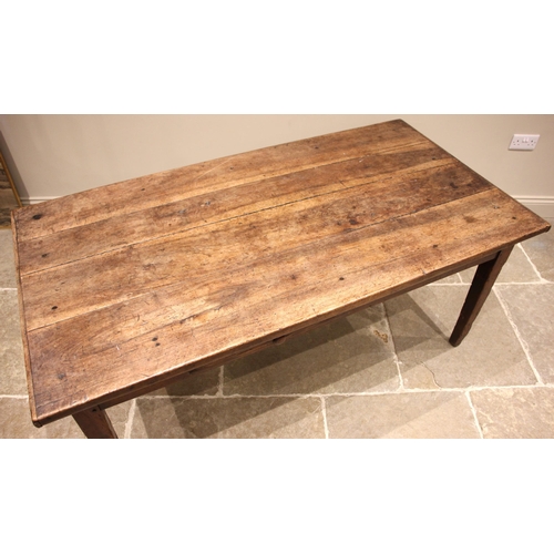 715 - A French walnut farmhouse kitchen table, early 19th century, the cleated three plank top over a sing... 