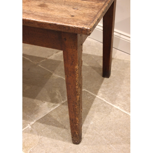 715 - A French walnut farmhouse kitchen table, early 19th century, the cleated three plank top over a sing... 