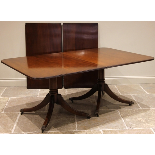 720 - A Regency style mahogany twin pedestal dining table, late 20th century, the oval top with a reeded e... 