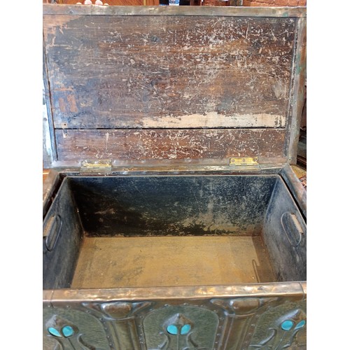 535 - An Arts and Crafts embossed copper covered wooden coal box/stool, in the manner of Archibald Knox, f... 